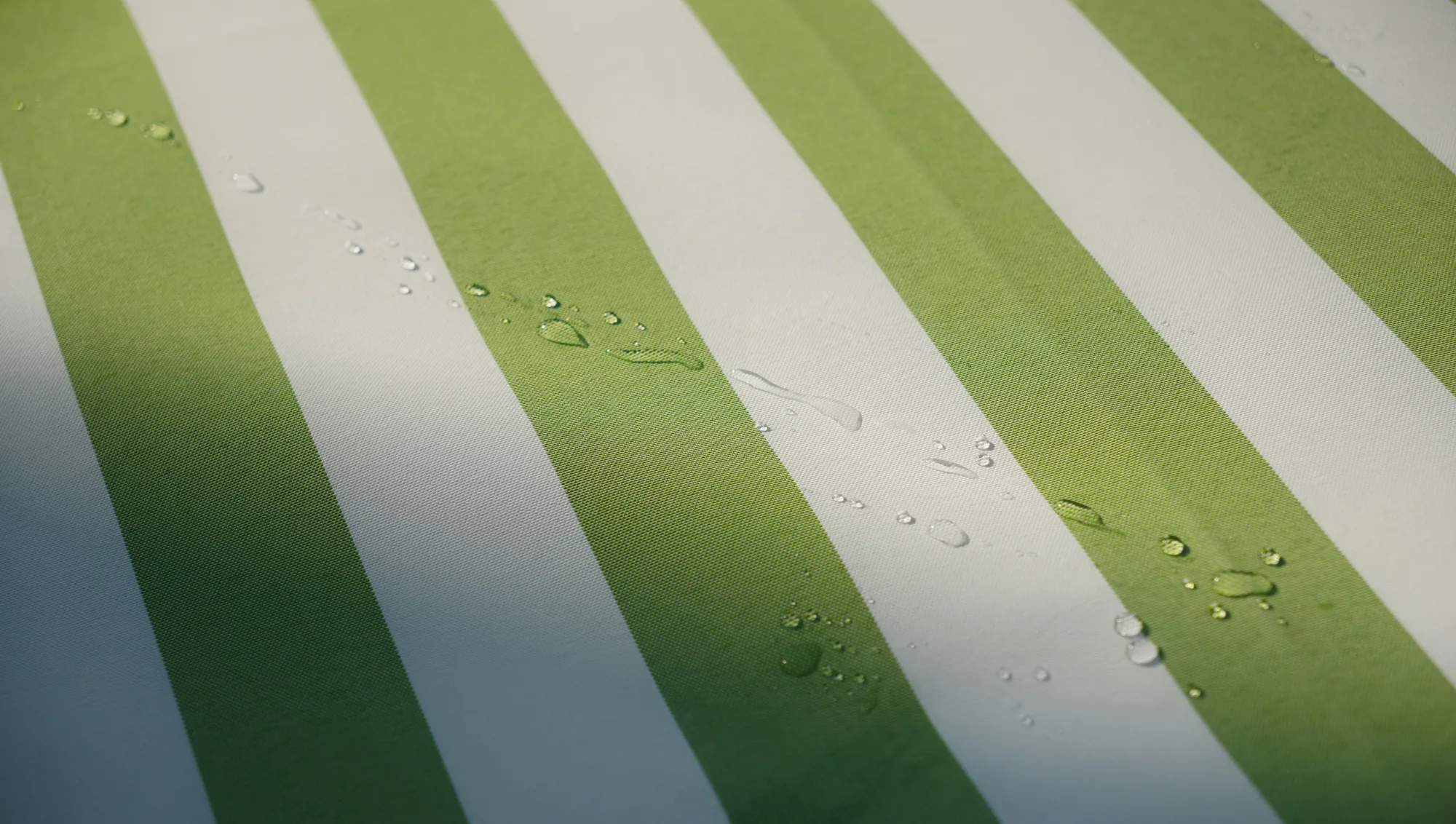 Water standing in beads on a coated cloth, none of it soaking in