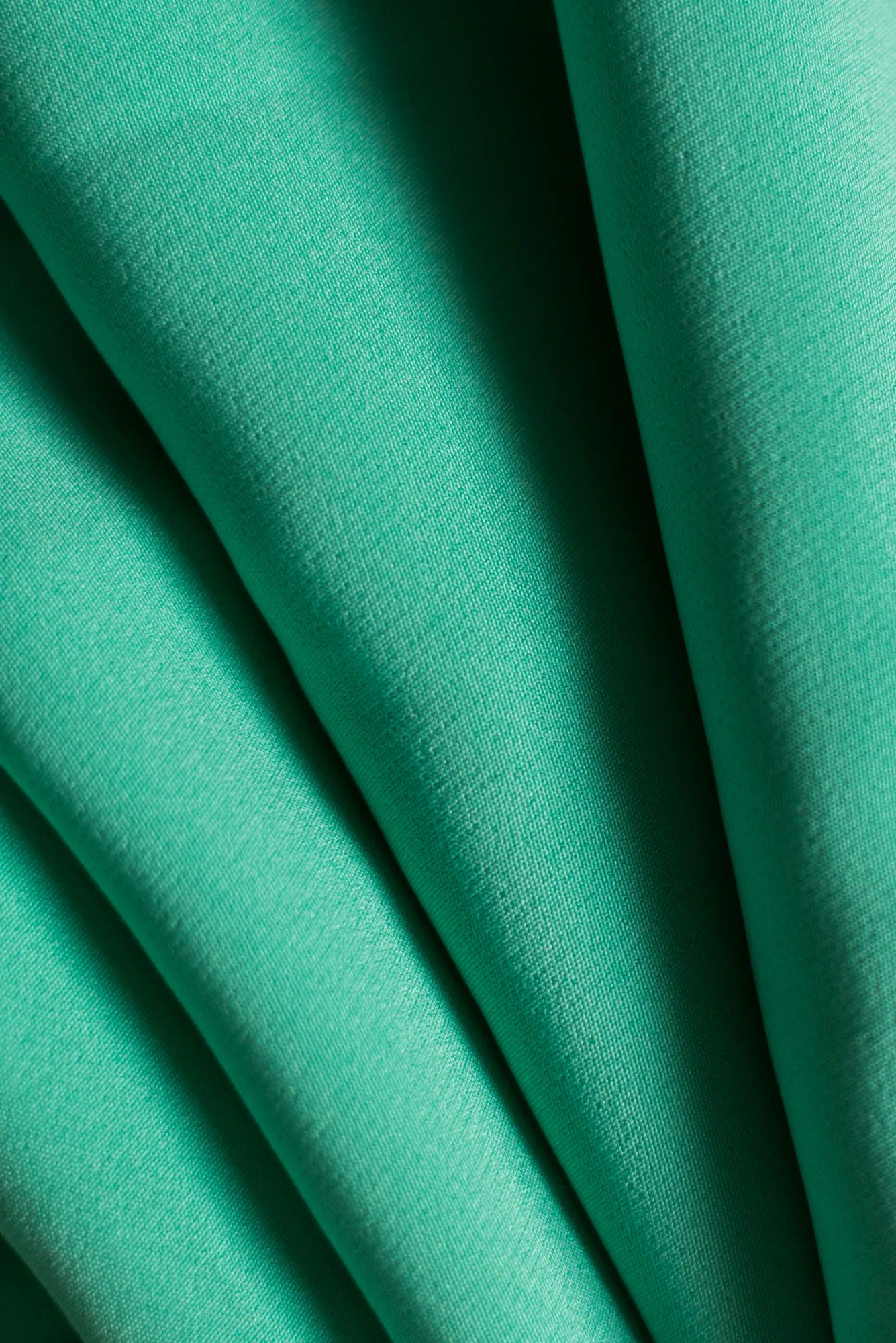 The cloth folded to show both faces, one matte and one slick